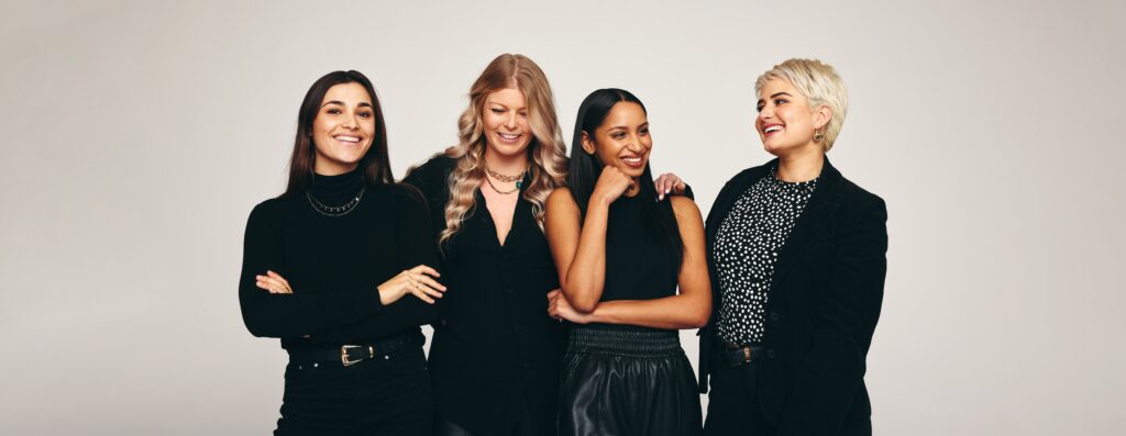 Four women standing, mentorship program